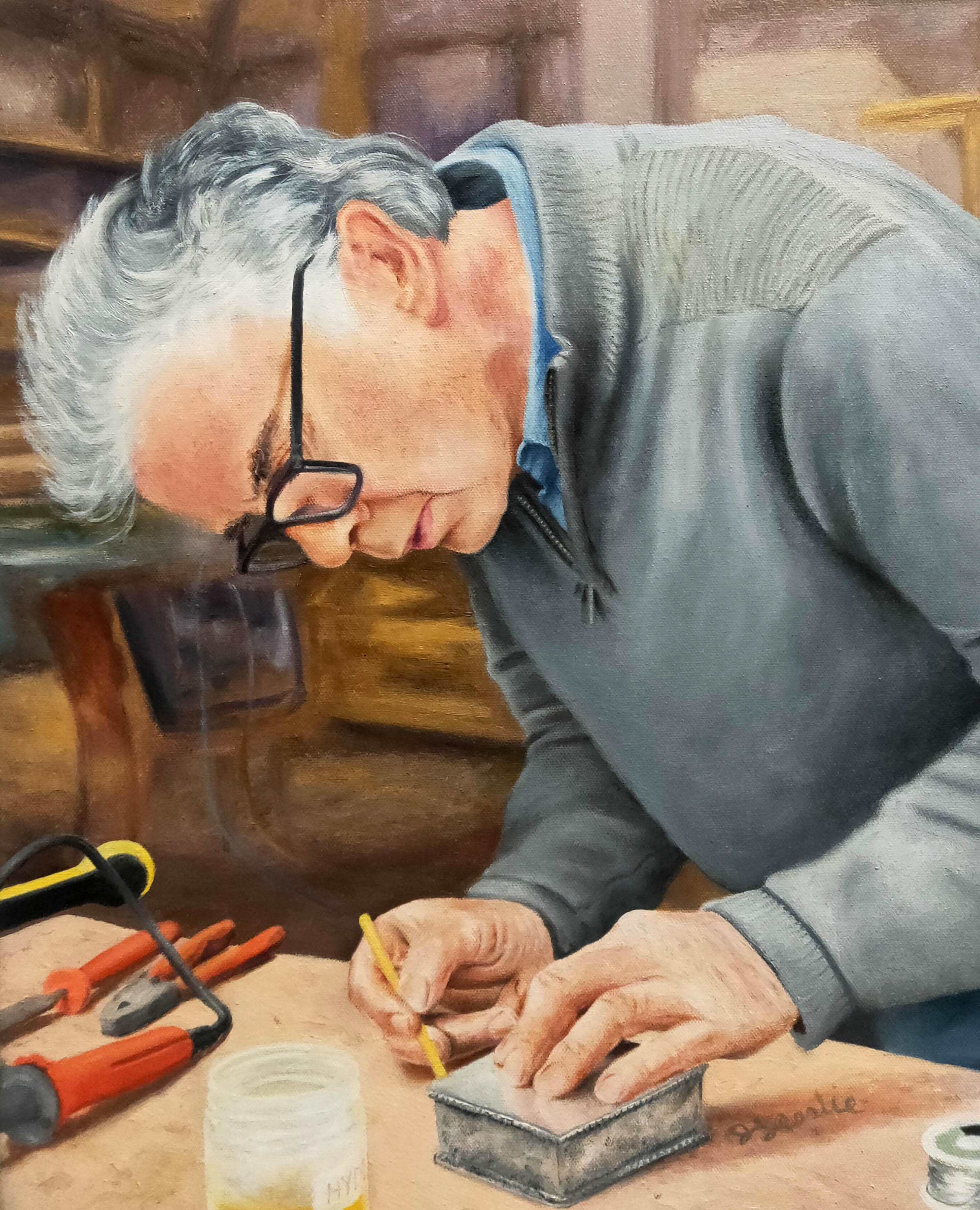 Tinker Richard At Work, a portrait by David Lesslie of a man concentrating on his work at a bench